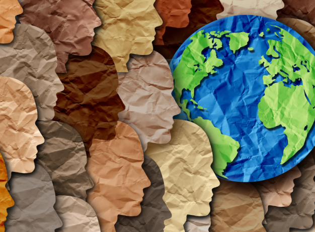 Paper-cut profiles of diverse skin tones form a background, with a globe prominently centered. The image symbolizes global diversity and unity.