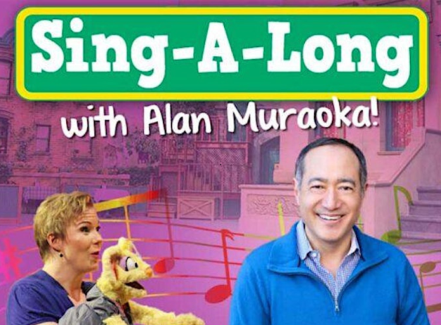 Vibrant 'Sing-A-Long with Alan Muraoka' poster. A smiling man in a blue sweater stands beside a woman with a puppet. Colorful musical notes overlay a purple background showcasing a lively, inviting atmosphere.