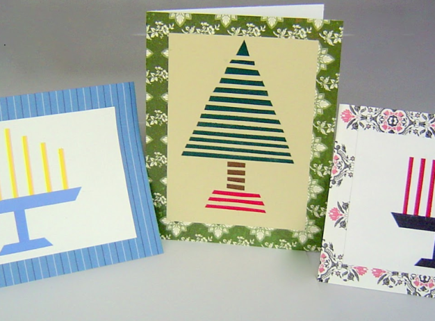 Three holiday cards are displayed. The first shows a blue menorah, the second has a striped Christmas tree, and the third features a menorah with colorful candles.