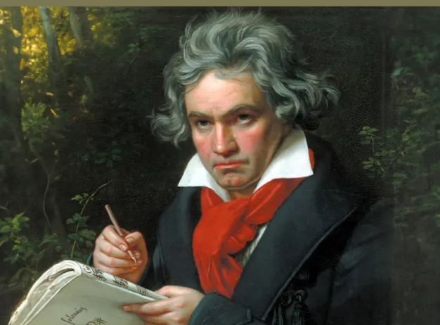 Portrait of a man with gray hair, wearing a dark coat and red scarf, holding a pen over a music sheet. He is set against a leafy, wooded background.