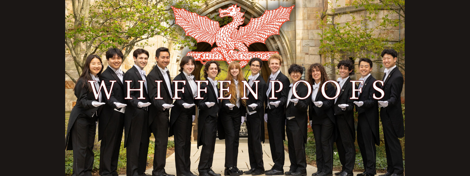 Group of 14 people in formal black suits stand in a line outside, smiling. They wear white gloves. "Whiffenpoofs" text overlays the image with an archway in the background.